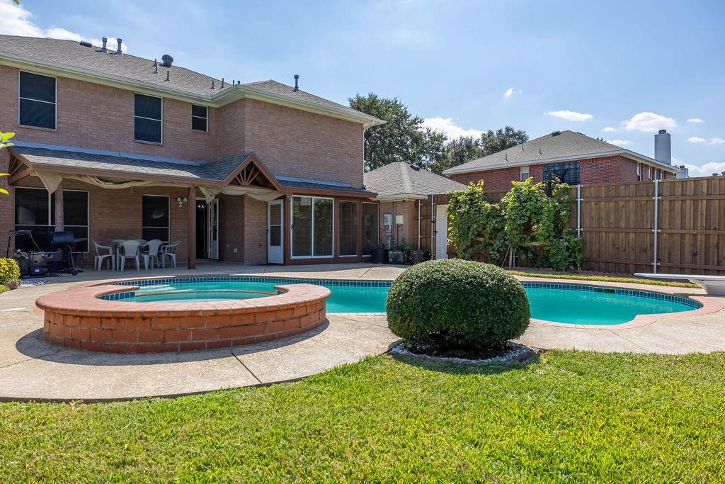 4113 Bluffpoint Road Rowlett, TX 75088 - Photo 37 of 39 View of swimming pool with a patio area, a pool with connected hot tub, and a sunroom