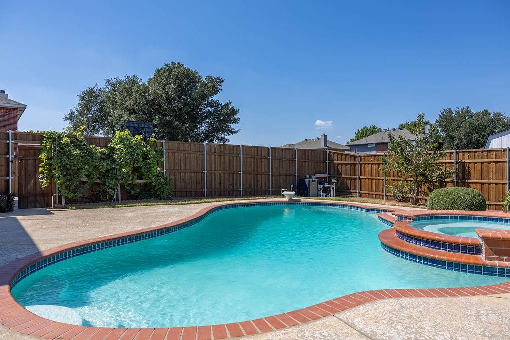 4113 Bluffpoint Road Rowlett, TX 75088 - Photo 38 of 39 View of pool featuring a fenced backyard, a patio area, and a pool with connected hot tub