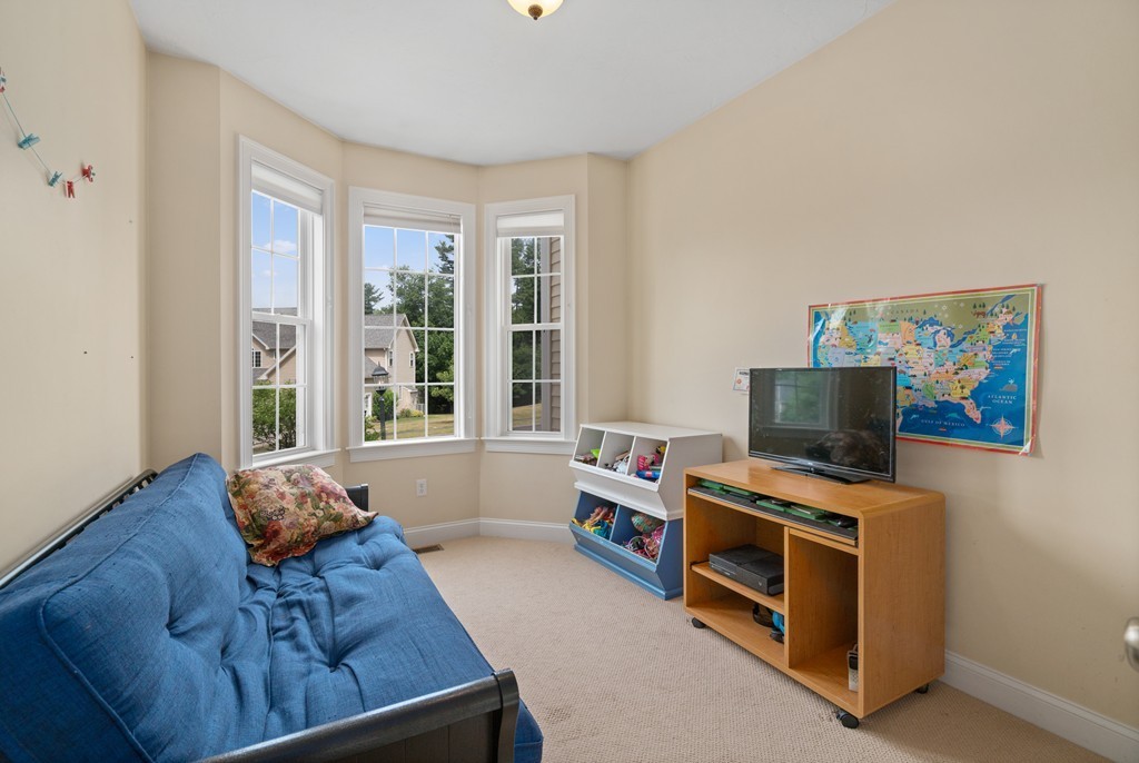 36 Draper Woods Road Sturbridge, MA 01518 - Photo 11 of 25 a living room with furniture and a flat screen tv