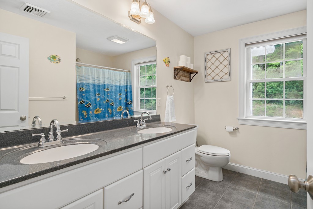 36 Draper Woods Road Sturbridge, MA 01518 - Photo 16 of 25 a bathroom with a granite countertop sink and a mirror