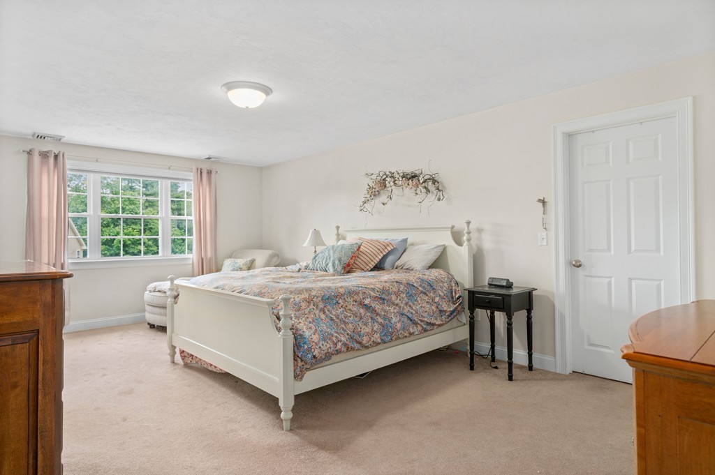 36 Draper Woods Road Sturbridge, MA 01518 - Photo 17 of 25 a spacious bedroom with a bed and a window