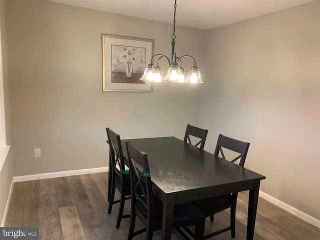 a view of a dining room with a table and chairs