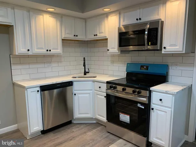 a kitchen with a stove and a microwave