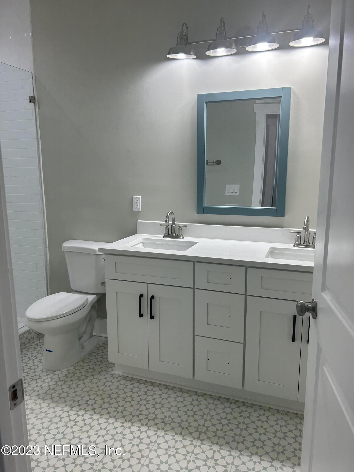 502 Twenty-First Street St. Augustine, FL 32084 - Photo 5 of 14 a bathroom with a sink a toilet and mirror