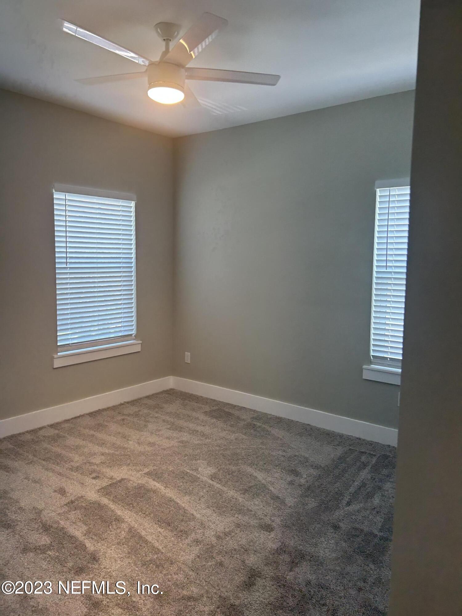 502 Twenty-First Street St. Augustine, FL 32084 - Photo 6 of 14 an empty room with windows and fan