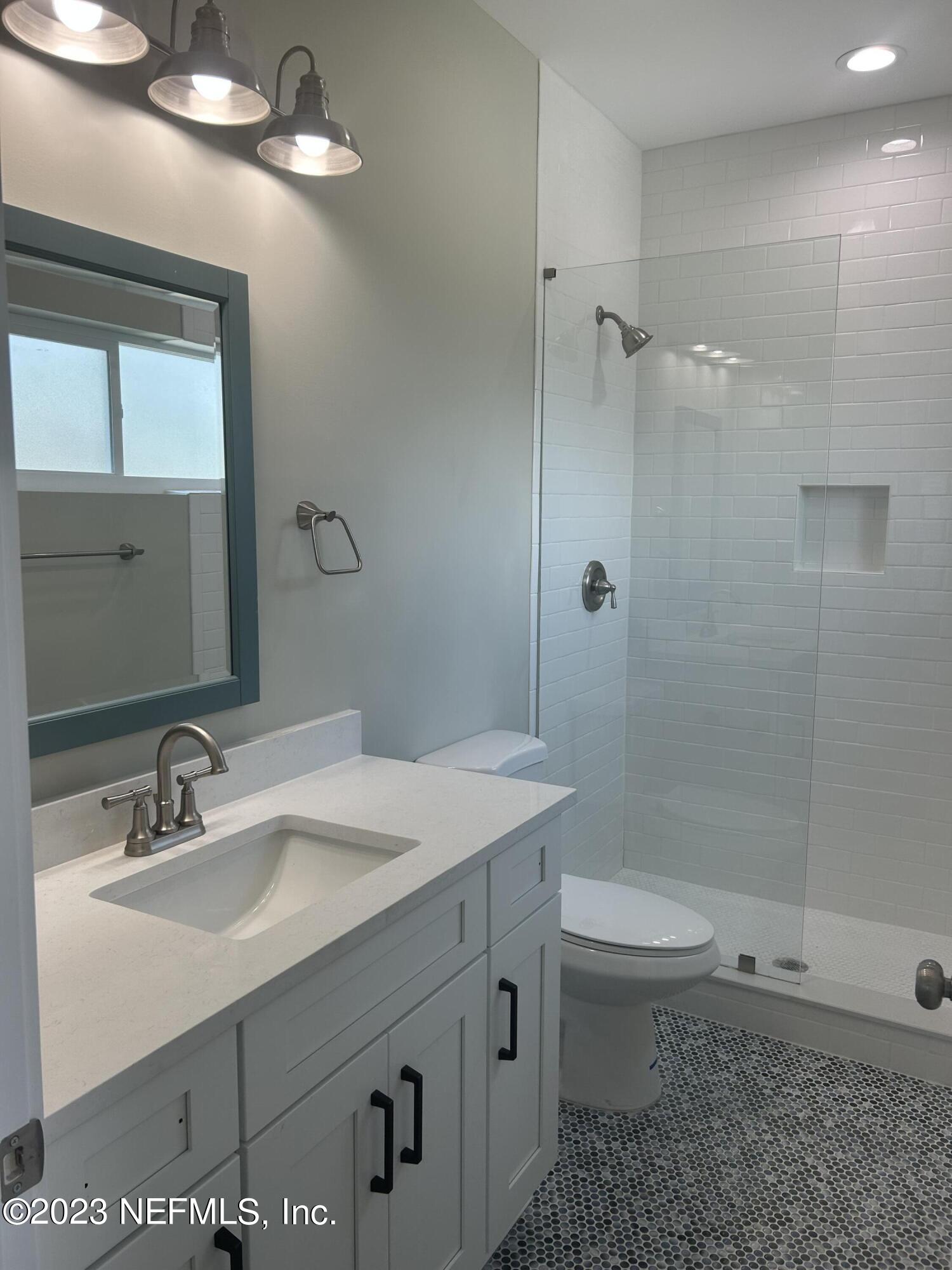 502 Twenty-First Street St. Augustine, FL 32084 - Photo 8 of 14 a bathroom with a sink a toilet and shower