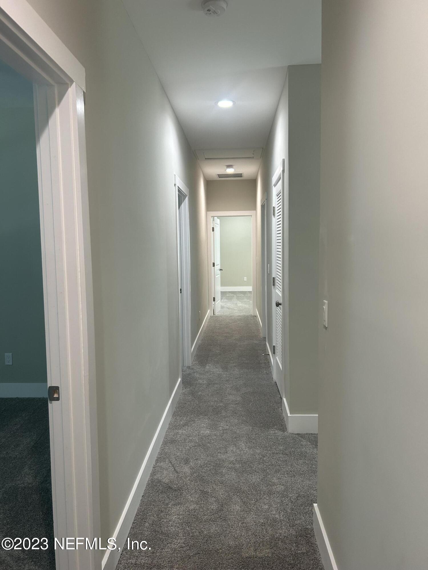 502 Twenty-First Street St. Augustine, FL 32084 - Photo 9 of 14 a view of a hallway with wooden floor