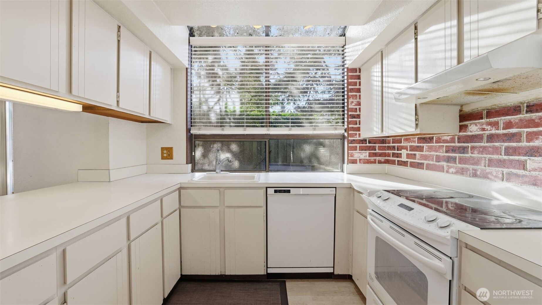 1850 Grant Avenue South, Unit D5 Renton, WA 98055 - Photo 11 of 25 a kitchen with white cabinets and a window