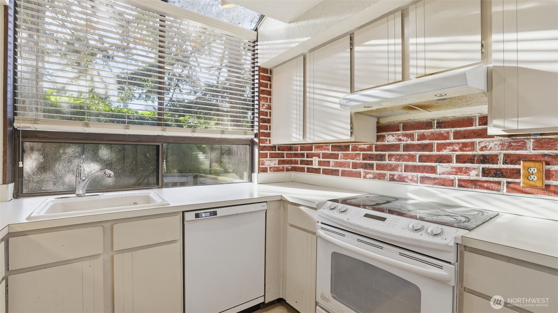 1850 Grant Avenue South, Unit D5 Renton, WA 98055 - Photo 12 of 25 a view of a kitchen with a sink and a large window