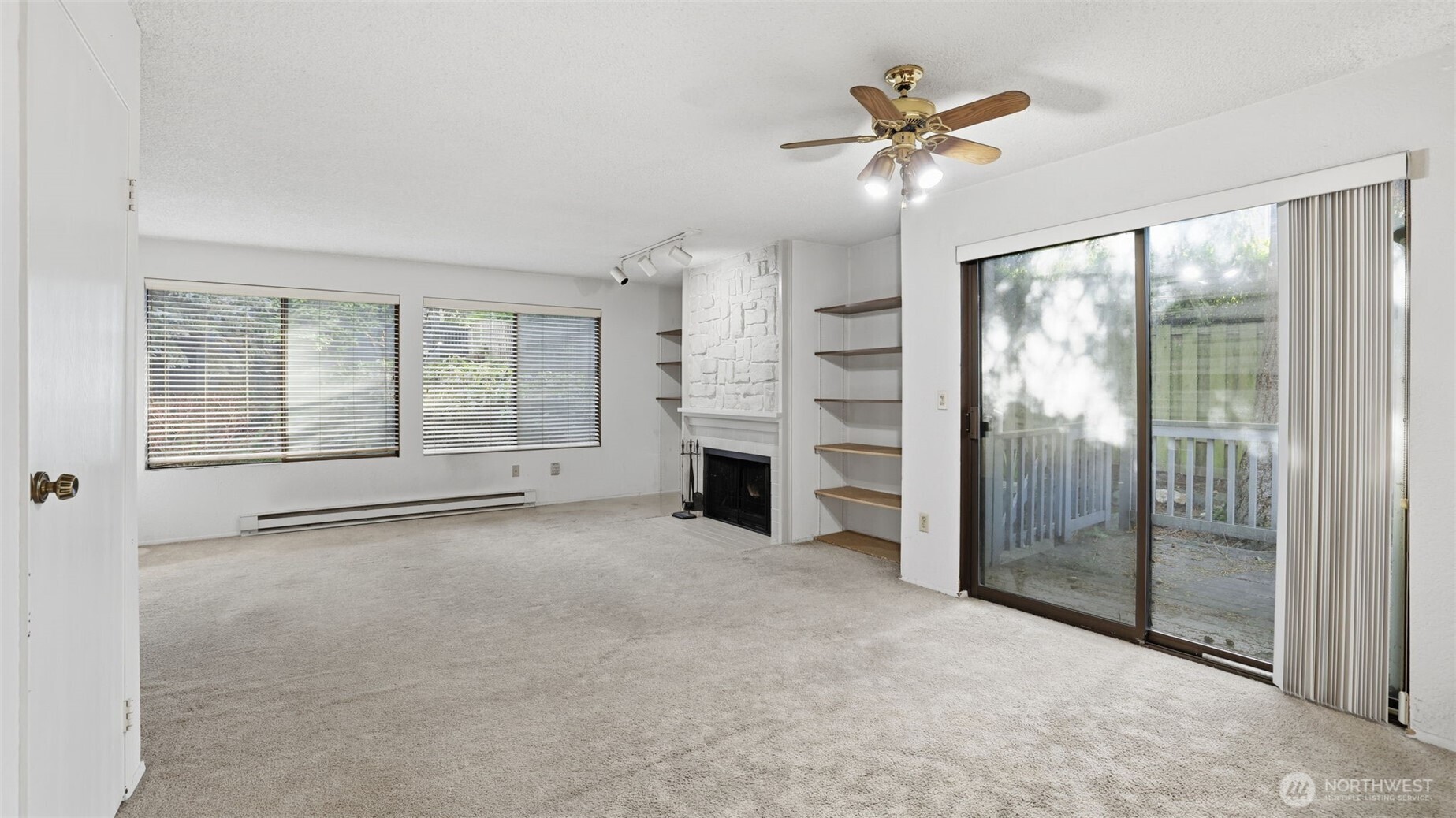 1850 Grant Avenue South, Unit D5 Renton, WA 98055 - Photo 5 of 25 a view of an empty room with a fireplace and a window