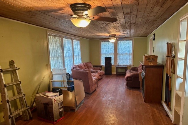 2320 Rusk Street Beaumont, TX 77702 - Photo 4 of 8 a living room with furniture a flat screen tv and a chandelier