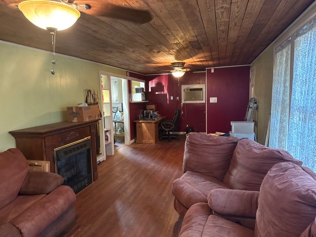 2320 Rusk Street Beaumont, TX 77702 - Photo 5 of 8 a living room with furniture a ceiling fan and a fireplace