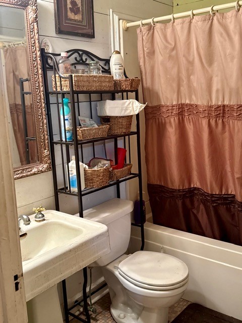 2320 Rusk Street Beaumont, TX 77702 - Photo 6 of 8 a bathroom with a sink a toilet and shower