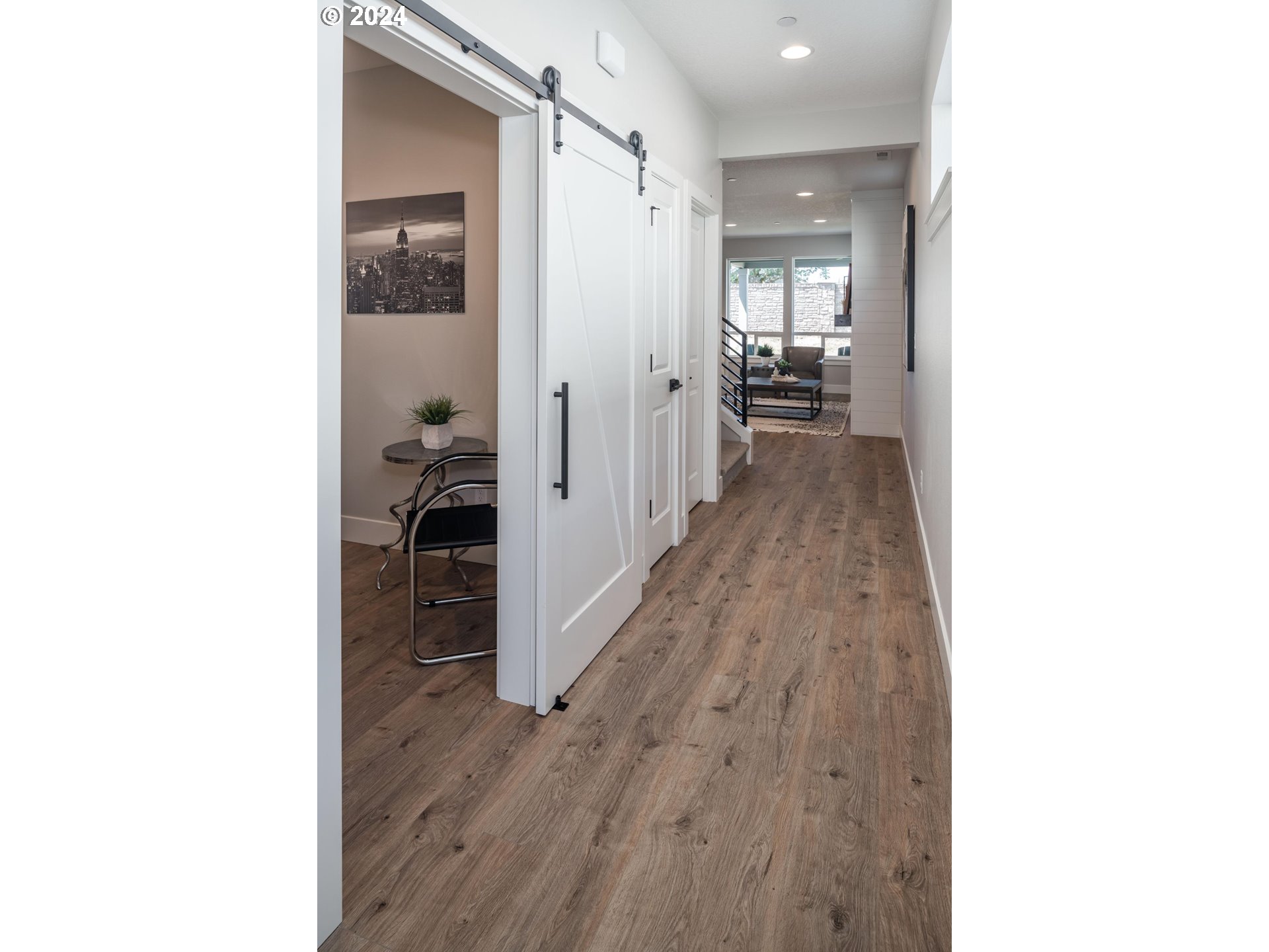 1017 South 46th Place Ridgefield, WA 98642 - Photo 3 of 23 a view of a hallway with wooden floor and a bathroom