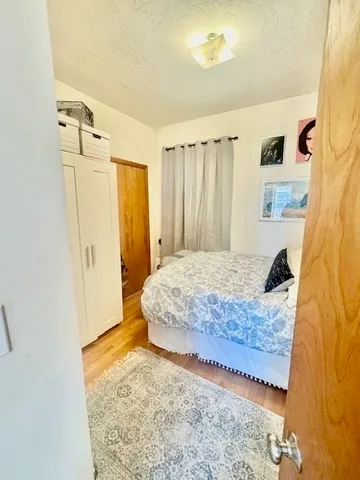 a bedroom with a bed and a mirror