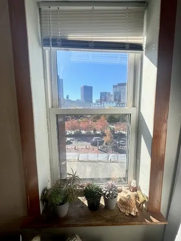 a window with a vase of flowers sitting on a table