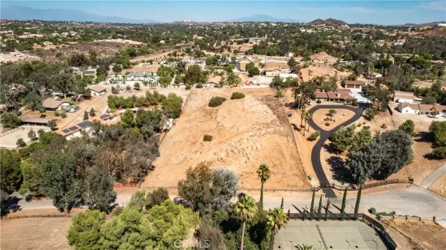 an aerial view of residential building and trees around
