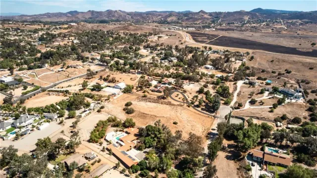 an aerial view of a residential houses with yard