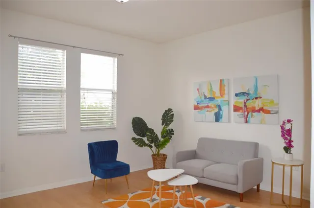 a living room with furniture and a potted plant