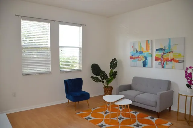 a living room with furniture and a potted plant