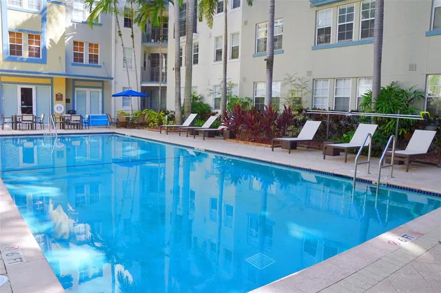 a view of a swimming pool with outdoor seating