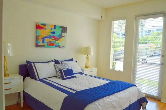 a bedroom with a bed and a painting on the wall