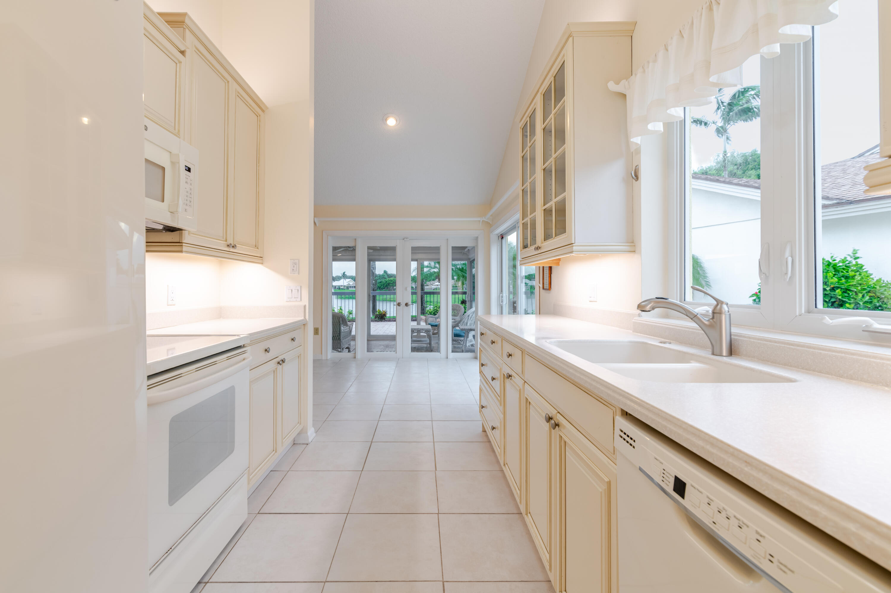 114 Beach Summit Court Jupiter, FL 33477 - Photo 24 of 97 a kitchen with granite countertop a sink stove and cabinets