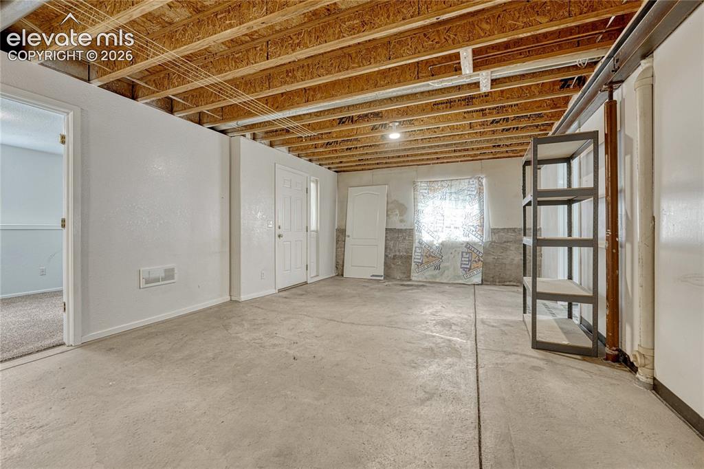 7285 Julynn Road Colorado Springs, CO 80919 - Photo 30 of 45 a view of empty room with windows