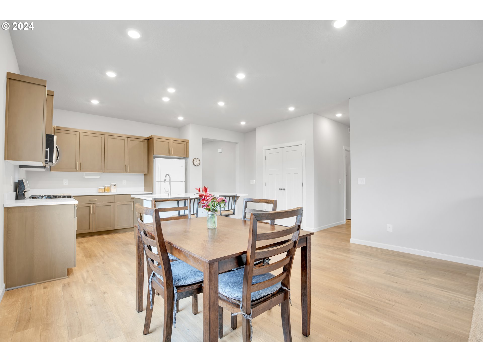 37332 Coho Street Sandy, OR 97055 - Photo 13 of 38 a kitchen with a dining table chairs and wooden floor