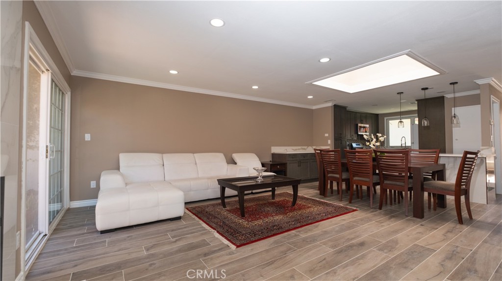 7 Satinwood Way Irvine, CA 92612 - Photo 1 of 15 a living room with furniture a dining table and a wooden floor