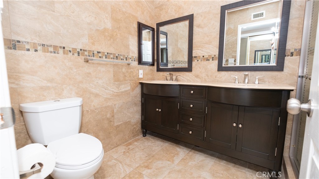 7 Satinwood Way Irvine, CA 92612 - Photo 5 of 15 a bathroom with a toilet sink and mirror