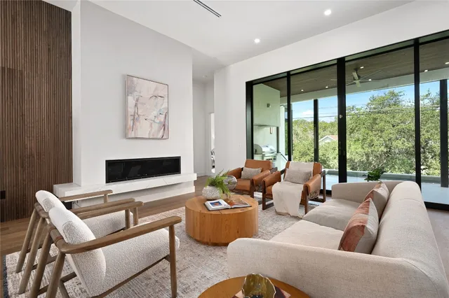 a large kitchen with kitchen island a stove a sink a center island and wooden floor