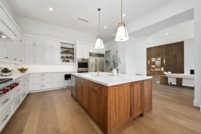a spacious bathroom with a double vanity sink a mirror and a shower