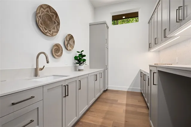 a view of small space with wooden floor and a window