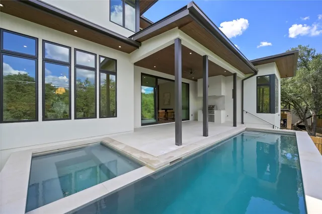 a front view of a house with a garden and yard
