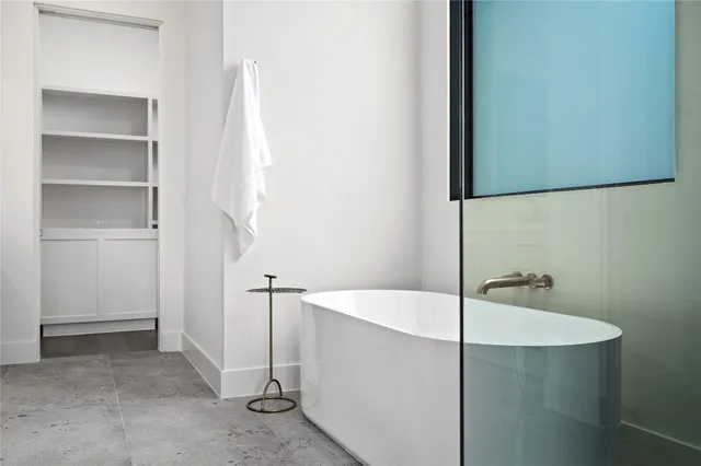 a view of empty room with wooden floor and window