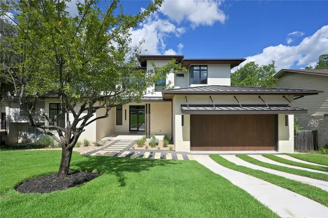 a living room with furniture and large windows