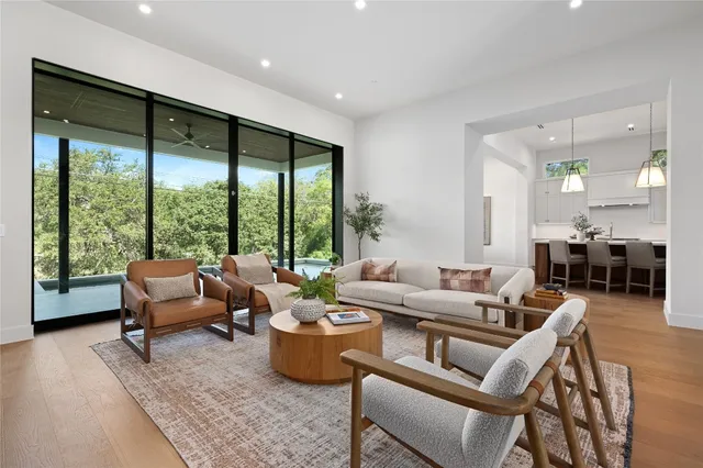 a kitchen with kitchen island granite countertop a sink a center island and cabinets