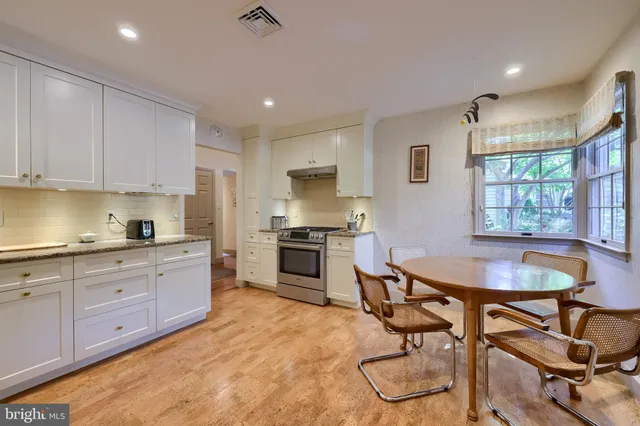 a kitchen with granite countertop a sink cabinets and window