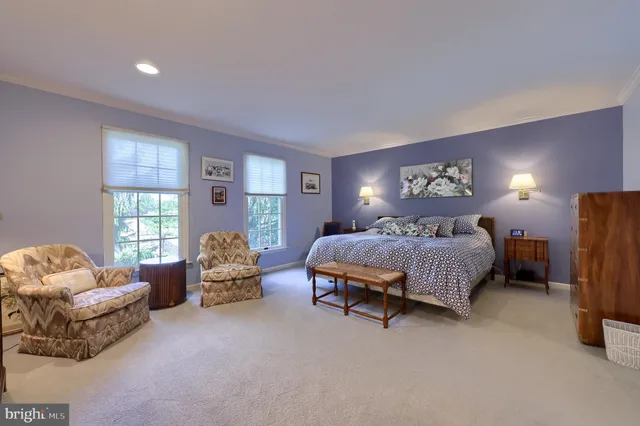 a spacious bedroom with a bed and a couch