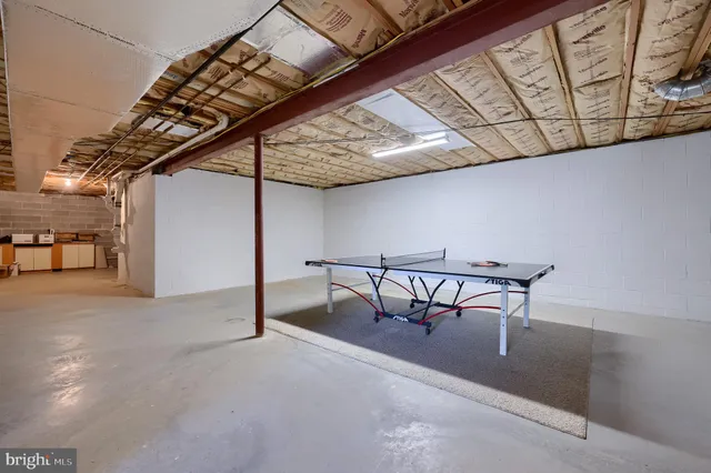 a view of a room with table and chairs