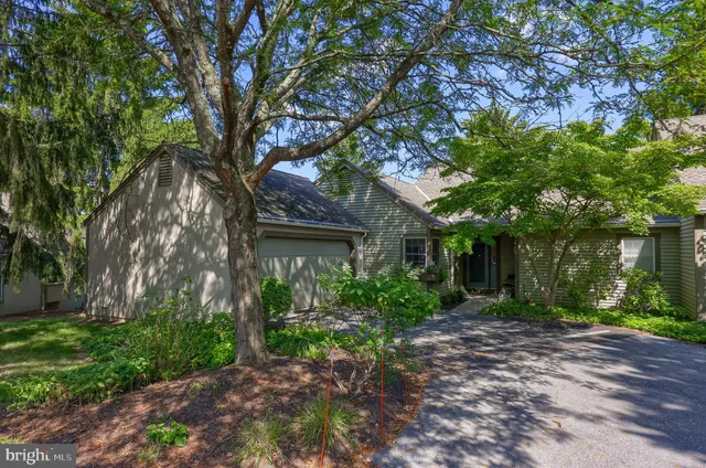 front view of a house with a tree