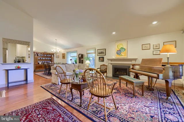 a living room with furniture a fireplace and a table