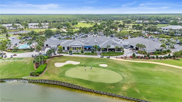 an aerial view of residential houses with outdoor space and swimming pool