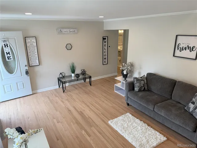 a living room with furniture and wooden floor