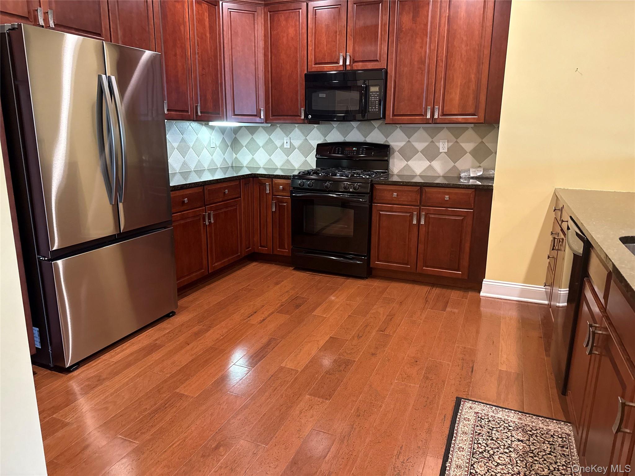 246 Regency Drive Fishkill, NY 12524 - Photo 10 of 20 a kitchen with stainless steel appliances granite countertop a refrigerator a stove top oven a sink and dishwasher