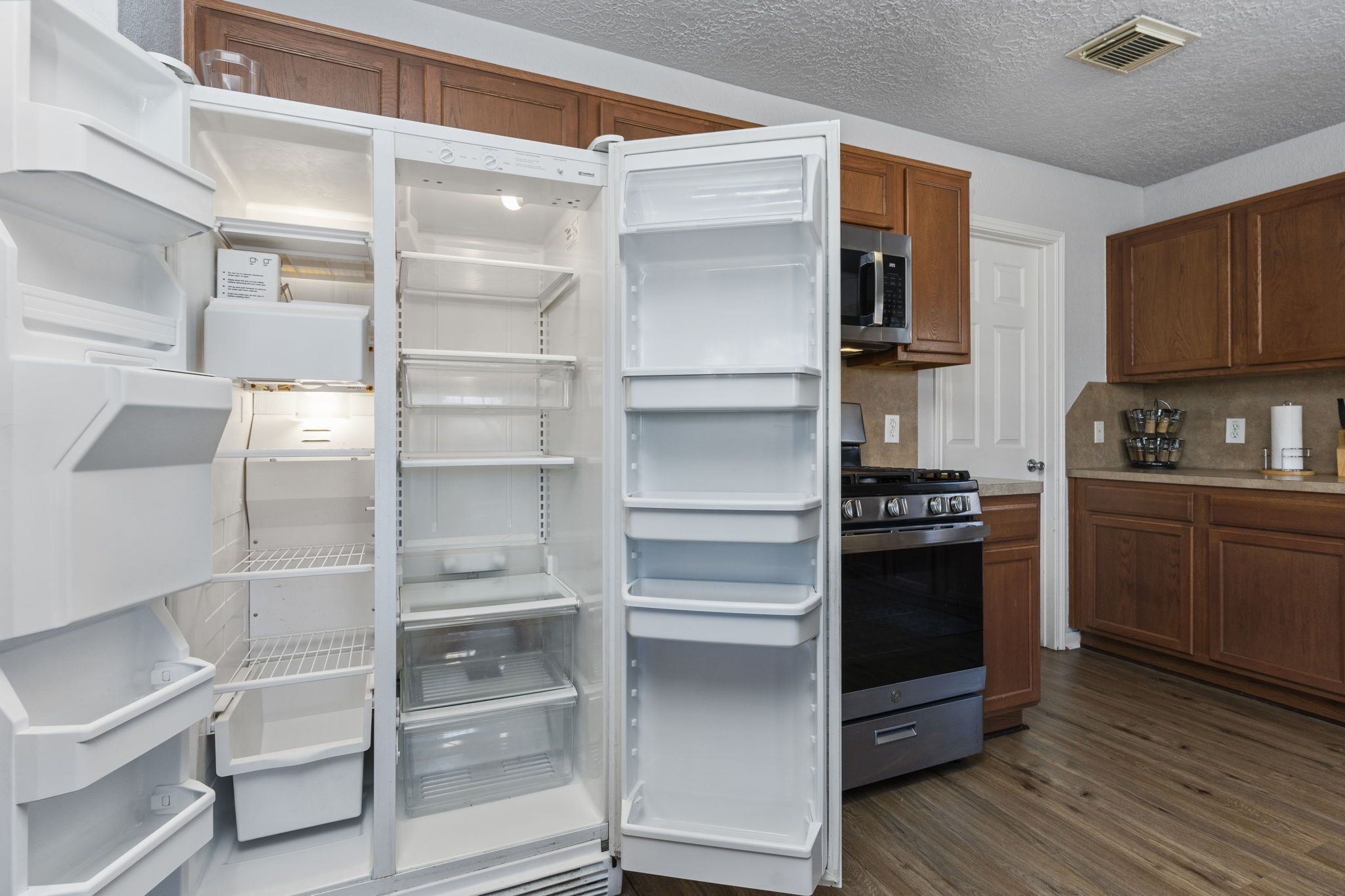 29326 Legends Green Drive Spring, TX 77386 - Photo 11 of 31 a kitchen with a refrigerator and a stove