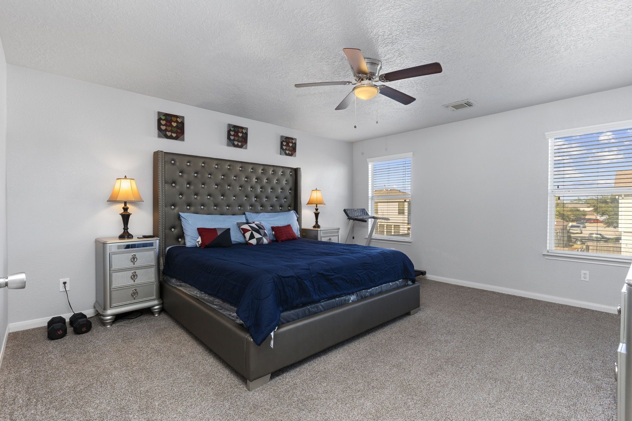 29326 Legends Green Drive Spring, TX 77386 - Photo 15 of 31 a bedroom with a bed and a chandelier