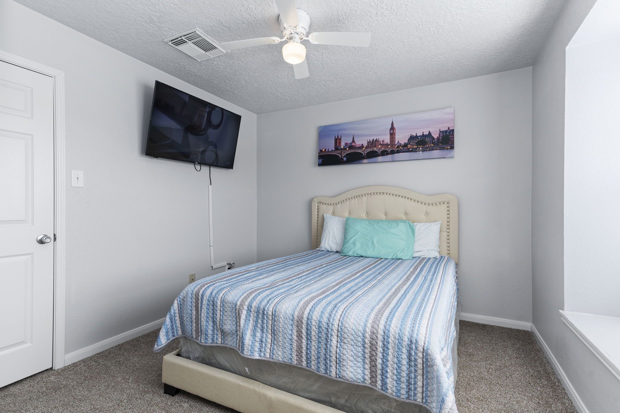 29326 Legends Green Drive Spring, TX 77386 - Photo 18 of 31 a bedroom with a bed and a flat screen tv