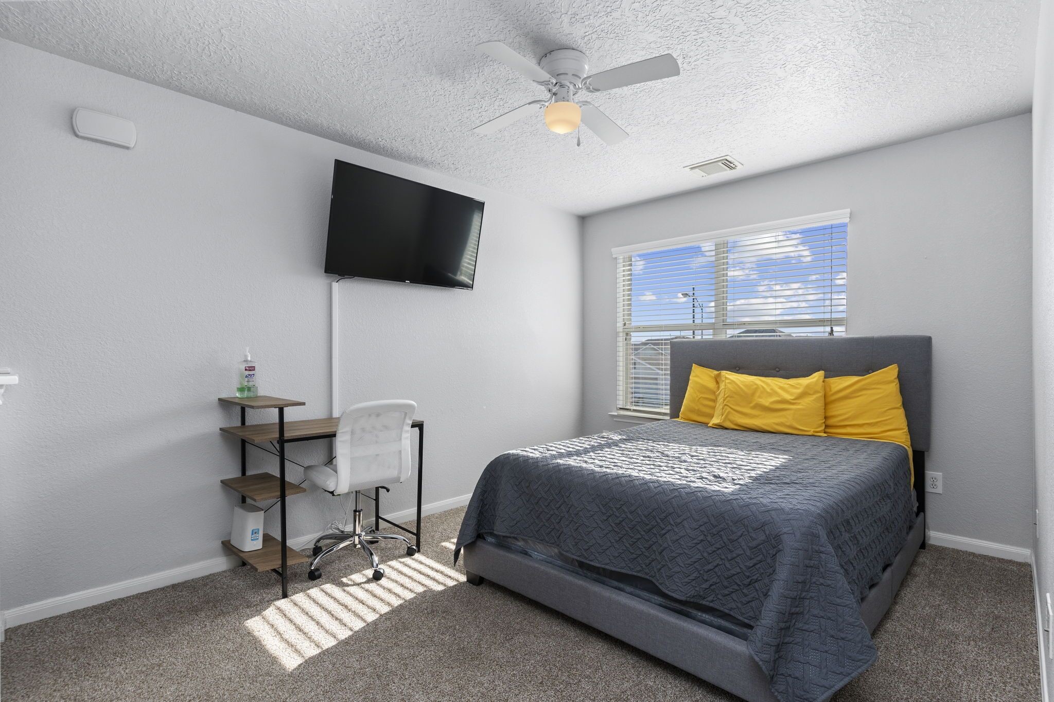 29326 Legends Green Drive Spring, TX 77386 - Photo 20 of 31 a bedroom with a bed a chair and a flat screen tv